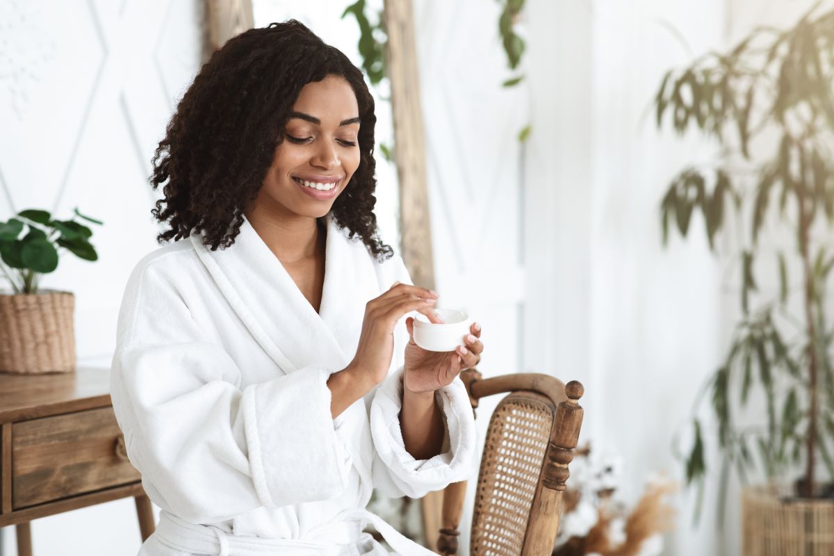 a lady performing using skincare products