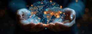 A conceptual graphic of hands holding digital world globe, symbolizing global connection and technology